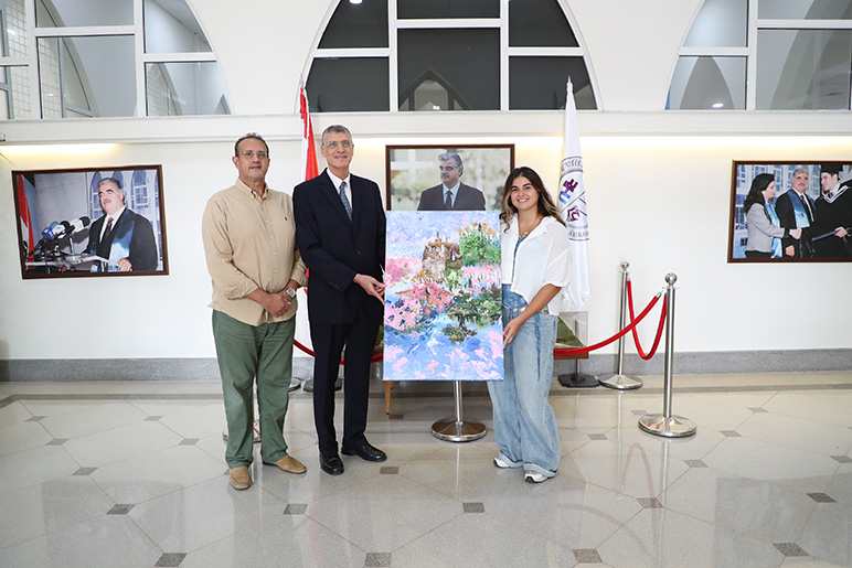 RHU President congratulates RHU graphic designer for academic excellence